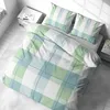 A neatly made bed with plaid bedding in green, blue, and white, shown from a high angle. Produktbild-Vorschau