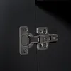 A close-up view of a black cabinet door with a silver hinge. Anteprima dell’immagine prodotto