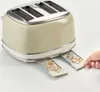 A hand is shown pulling out the crumb tray of a cream-colored toaster. Produktbild-Vorschau