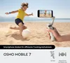 A child playing soccer on a beach while a hand holds a smartphone gimbal. Voir les images du produit