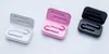 Three open charging cases for wireless earbuds, each containing a pair of earbuds. The cases are white, pink, and black. Produktbild-Vorschau