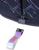 Close-up of a zipper pull and a reflective strap from a backpack. Voir les images du produit