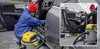 A person is vacuuming the interior of a car with a wet/dry vacuum cleaner. Anteprima dell’immagine prodotto