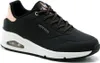 A side view of a black Skechers women's sneaker with a white sole and rose gold accents. Náhled obrázku produktu