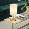 A modern living room scene with a green sofa, a side table, and a table lamp. Náhľad obrázku produktu
