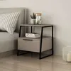 A modern nightstand with a drawer next to a bed, decorated with a pitcher of water, a plant, and books. Voir les images du produit