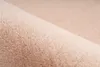 A close-up, angled view of a soft, plush fabric, likely a rug or blanket, with a gentle curve creating a sense of depth. Produktbild-Vorschau