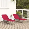 Two red sun loungers on a wooden deck with plants in the background. Produktbild-Vorschau