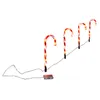 Four illuminated candy canes arranged diagonally on a white background. Produktbild-Vorschau