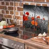 A kitchen counter with a stovetop, cooking utensils, and a decorative panel featuring poppies. Produktbild-Vorschau