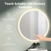 A hand is touching a round LED mirror with a light ring, in a bathroom setting. Voir les images du produit