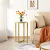 A side table with a vase of flowers sits next to a sofa with a throw blanket. Produktbild-Vorschau