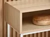 A close-up view of a modern console table with a wooden shelf and a wooden box on it. Náhled obrázku produktu