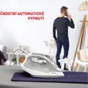 A man is on the phone while an iron is on an ironing board. Produktbild-Vorschau