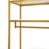 A close-up view of a gold-colored clothing rack with white shelves. Podgląd zdjęcia produktu