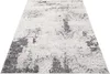 A close-up, angled view of a rug with a distressed, abstract pattern. Produktbild-Vorschau
