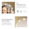 Collage of images showing a makeup mirror with lights, a close-up of a woman's eye magnified, and two suction cups. Produktbild-Vorschau