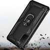 A black phone case with a ring holder is shown in a dramatic, action-oriented scene with debris flying around it. Produktbild-Vorschau