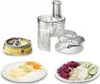 A food processor with various attachments and sliced vegetables on plates. Podgląd zdjęcia produktu