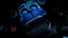 A close-up, low-angle shot of an animatronic character's face in a dark environment. Náhled obrázku produktu