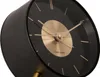 A close-up view of a black Karlsson alarm clock with a gold disc. Anteprima dell’immagine prodotto