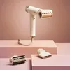 A white Shark hair dryer with attachments is displayed on pink blocks against a pink background. Voir les images du produit