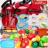 A collection of toy kitchen accessories, including pots, pans, utensils, and play food, arranged on a white surface. Anteprima dell’immagine prodotto