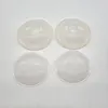 Four clear plastic breast shells are arranged in a two-by-two grid on a white background. Náhľad obrázku produktu