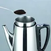 A close-up shot of a stainless steel coffee percolator with a spoon of coffee grounds being added. Náhľad obrázku produktu