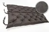 A dark gray tufted bench cushion is shown against a white background. A circular inset shows a close-up of the fabric texture. Produktbild-Vorschau