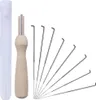 A set of felting needles with a wooden handle and a clear plastic storage tube. Produktbild-Vorschau