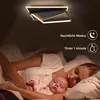 A woman and a baby sleeping in a bed, with a modern ceiling lamp visible above. Náhľad obrázku produktu