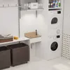 A laundry room with a sink, washing machine, dryer, and storage baskets. Produktbild-Vorschau