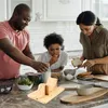 A family preparing food in a kitchen. Produktbild-Vorschau