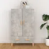 A highboard with a concrete gray finish and wooden handles, placed against a white wall with a wooden floor. A plant is visible to the right. Náhľad obrázku produktu