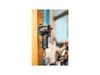 A pneumatic impact wrench is hanging from a hook on a wooden post. Produktbild-Vorschau