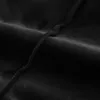A close-up view of black fabric with a visible seam. Podgląd zdjęcia produktu