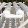 A close-up view of a hydroponic growing system with multiple tubes and holes for plants. Podgląd zdjęcia produktu