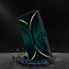 A phone case with a dark green and gold abstract design is shown in a dramatic, angled shot, appearing to be dropped onto a cracked surface with a blue glow beneath it. Produktbild-Vorschau