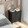 A bedside table with drawers next to a bed, decorated with a vase of greenery and candles. Anteprima dell’immagine prodotto