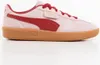 A side view of a pink Puma sneaker with red accents and a gum sole. Produktbild-Vorschau