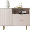 A light pink cabinet with fluted doors and drawers, decorated with a white vase and a teapot on top. Produktbild-Vorschau