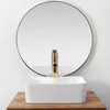 A white rectangular vessel sink with a gold faucet is placed on a wooden surface in front of a large round mirror. Anteprima dell’immagine prodotto