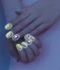 A close-up shot of a person's hands with glowing nail art. Anteprima dell’immagine prodotto