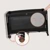 A hand is shown adjusting the top of a black travel crib. Close-up insets highlight the mesh fabric and a wheel lock. Voir les images du produit