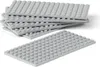 A stack of gray LEGO baseplates and one baseplate in the foreground, all on a white background. Voir les images du produit