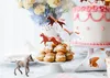 A birthday party table setting with a cake, cream puffs, and horse-themed decorations. Produktbild-Vorschau