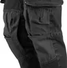 A close-up view of dark denim work pants with reinforced knee areas. Produktbild-Vorschau
