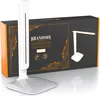 A white desk lamp is placed in front of its black and orange packaging box, which displays an illustration of the lamp and product details. Anteprima dell’immagine prodotto