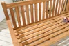 A close-up view of a wooden garden bench on a light-colored deck. Produktbild-Vorschau